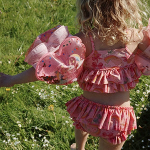 Konges Sløjd Manuca Frill Bikini Rainbow Bow – adorable girls bikini with rainbow bows, available at 1Love 2Hugs 3Kisses Ibiza.