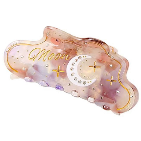 Moon Magic Hair Claw in iridescent lilac with gold moon and star details and crystal rhinestones.