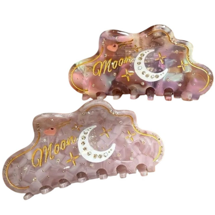 Moon Magic Hair Claw in iridescent lilac with gold moon and star details and crystal rhinestones.